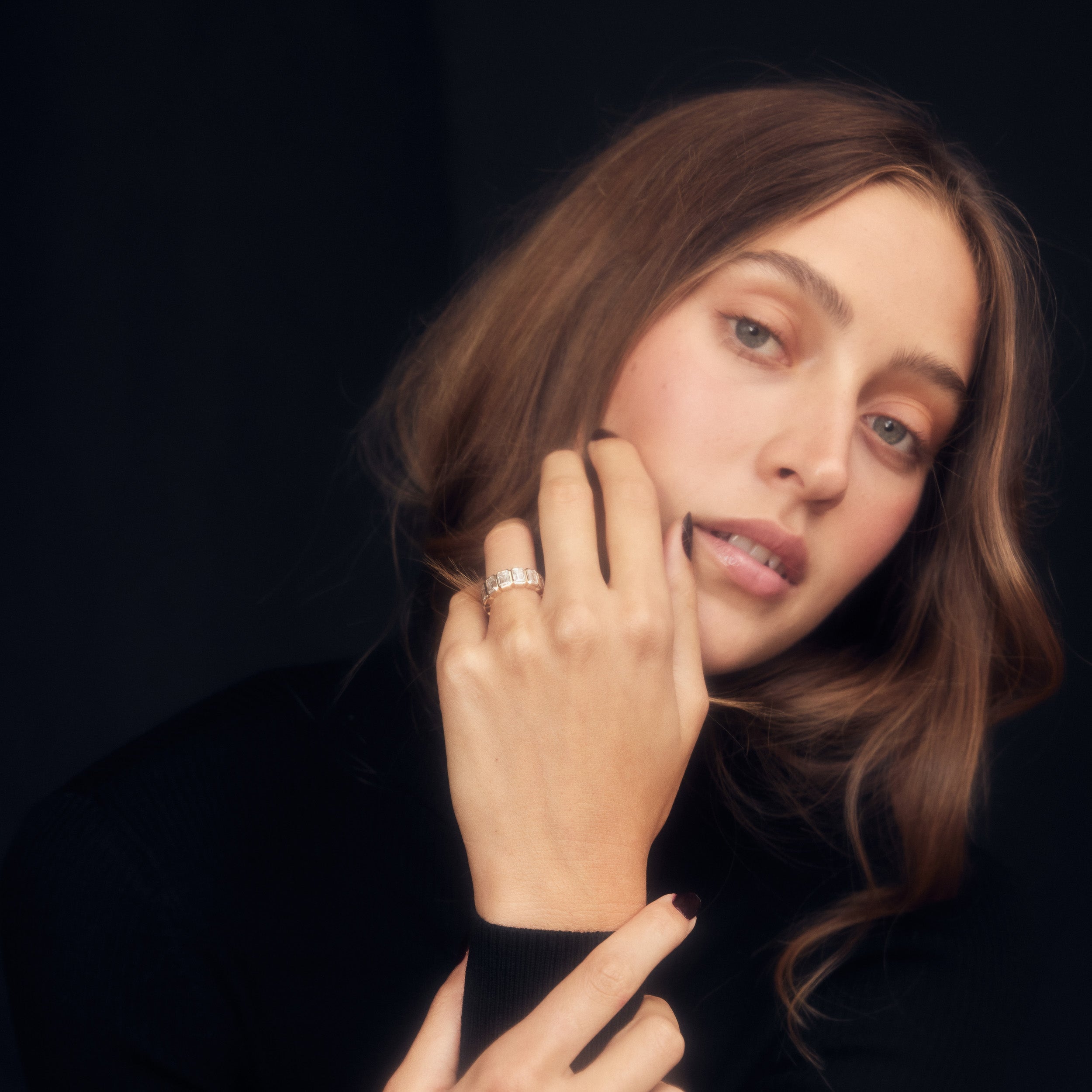 Moissanite eternity band with bezel set emerald cut stones